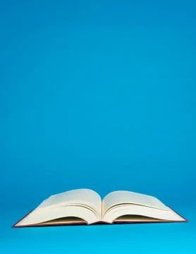 Open book on a blue background Stock Photos