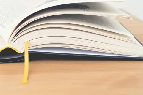 Open book with bookmarks on table. Back to school. Stock Photos