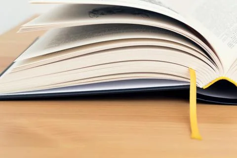 Open book with bookmarks on table. Back to school. Stock Photos