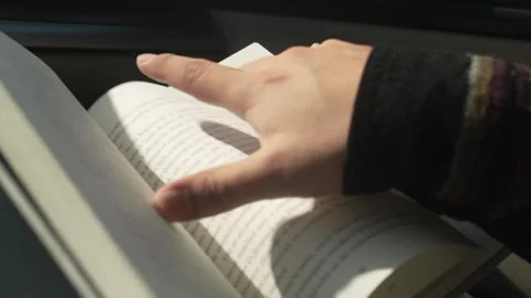 An open book bouncing as a person is reading in the car Stock Footage 260872767