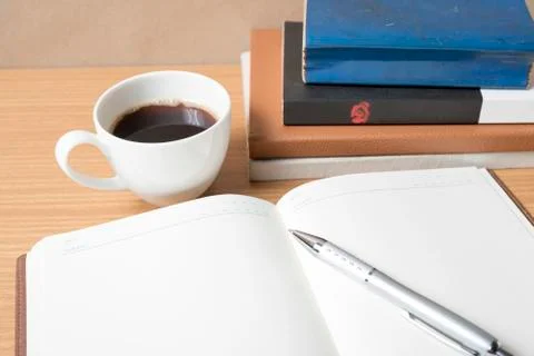Open book with coffee cup Stock Photos