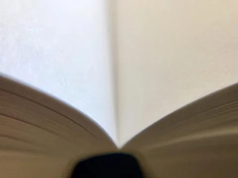Open book on dark table Stock Photos