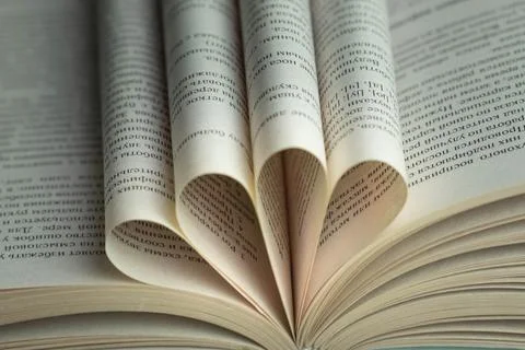 An open book with folded pages in the shape of a heart Stock Photos