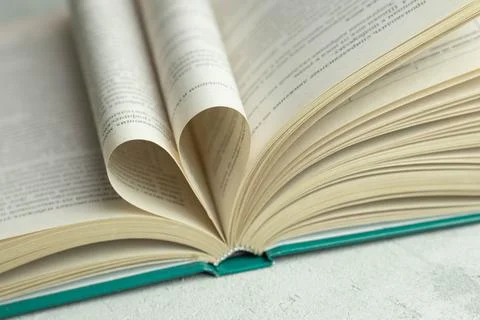 An open book with folded pages in the shape of a heart Stock Photos
