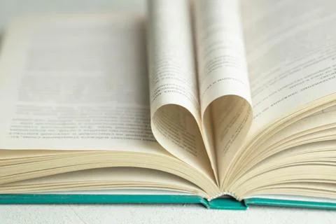 An open book with folded pages in the shape of a heart Stock Photos