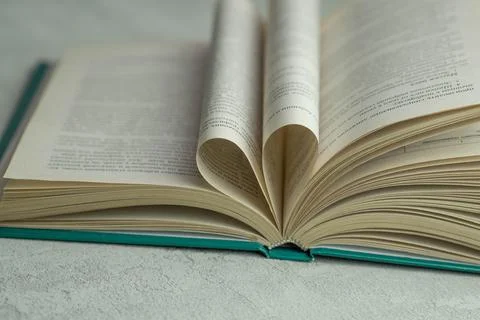 An open book with folded pages in the shape of a heart Stock Photos