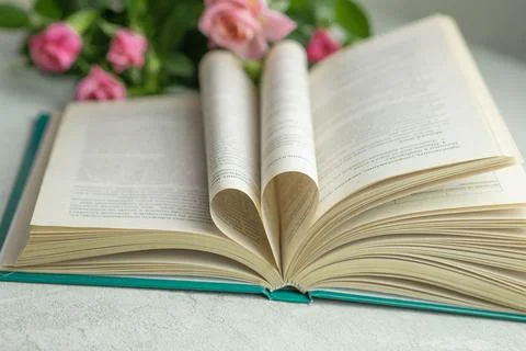 An open book with folded pages in the shape of a heart Stock Photos