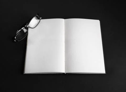 Open book, glasses Stock Photos