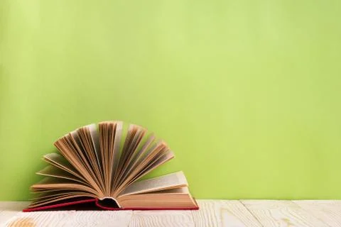 Open book on green wooden bavkground. Education background 写真素材