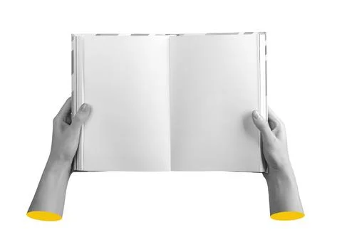 Open book in hand showing textless pages. Clean and blank layout suggests a Stock Photos