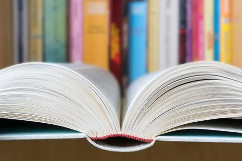 Open book with a library in background Stock Photos