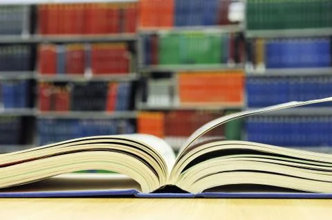 Open book on library table Stock Photos