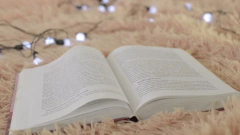 Open book. Lights flashing in the background. Close-up 動画素材 96627149