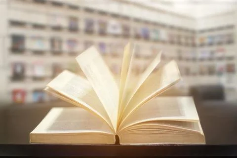 Open book on modern library background. Stock Photos