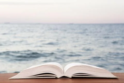 Open book over the landscape background Stock Photos