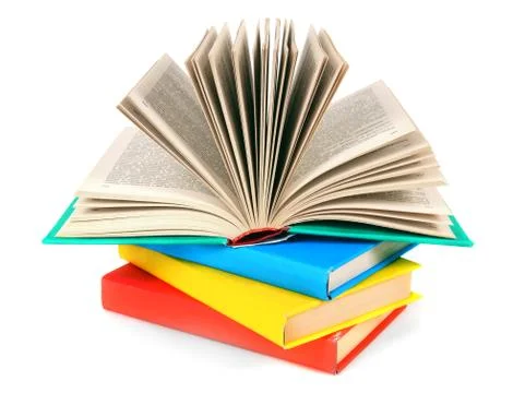 The open book on a pile of multi-coloured books. 스톡 사진