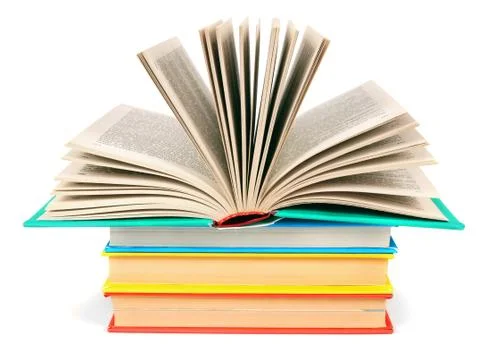 The open book on a pile of multi-coloured books. 스톡 사진