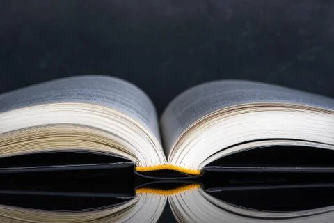 Open book with reflection on table Stock Photos