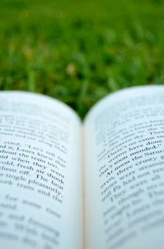 Open book on some grass Stock Photos