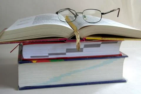 Open book with a spectacle Stock Photos