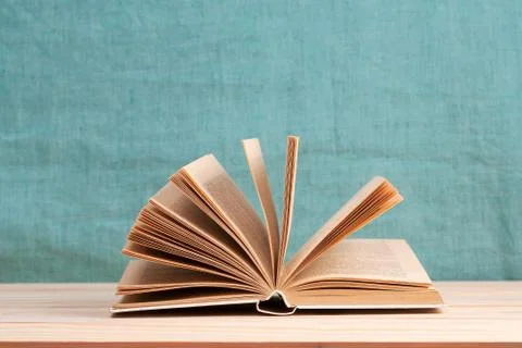 Open book, stack of hardback books on wooden table.  Back to school. Copy space Stock Photos