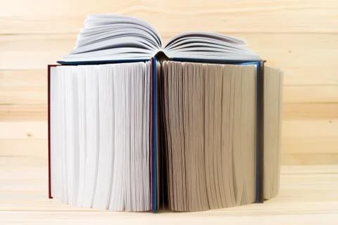 Open book, stack of hardback books on wooden table. Back to school. Copy space Foto stock