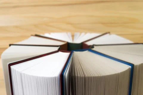 Open book, stack of hardback books on wooden table. Back to school. Copy space Stock Photos