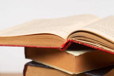 Open book, stack of hardback books. Back to school Stock Photos
