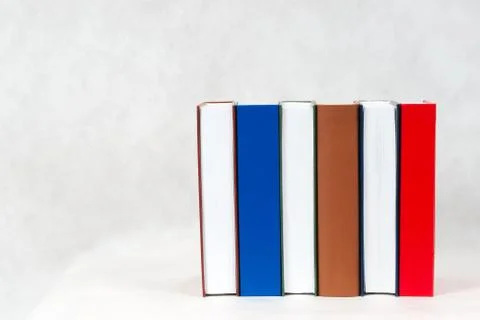 Open book, stack of hardback books on wooden table Stock Photos