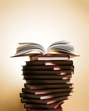 An open book on a stack of red books in the form of a spiral. Stock Photos