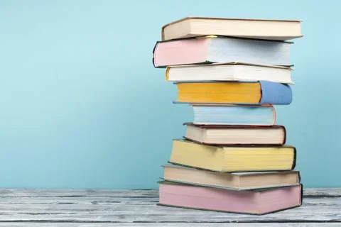 Open book, stacking, hardback books on wooden table and background. Back to s Stock Photos