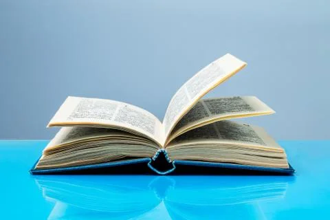 Open book on the table, free access to knowledge and information concept Stock Photos