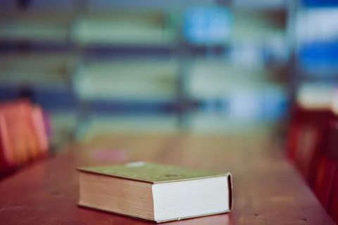 Open book on the table in library Stock Photos