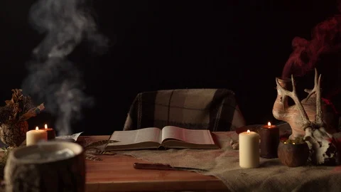 Open book on table with magic items Stock Footage 125838669