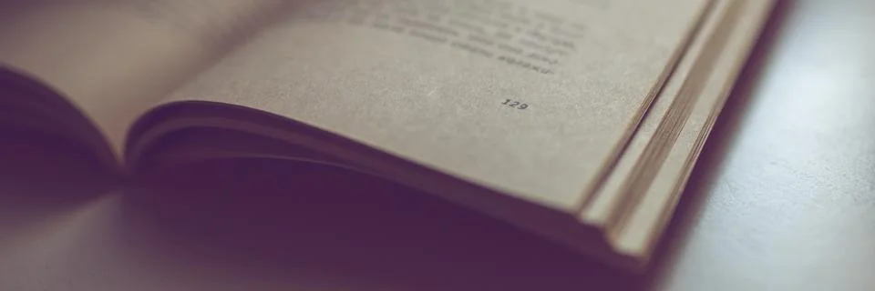 Open book on the table. Side view, closeup. Page 129. Stockfoto's