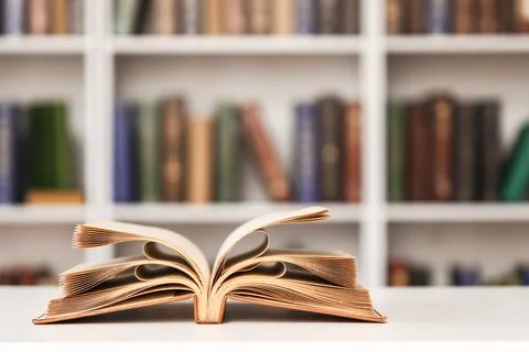 Open book on table in stylish home library, closeup Fotos de archivo