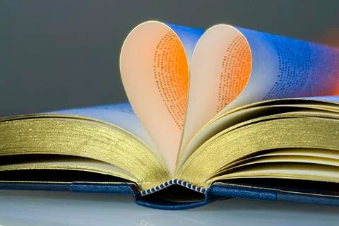 Open book, two pages folded into the shape of a heart Stock Photos