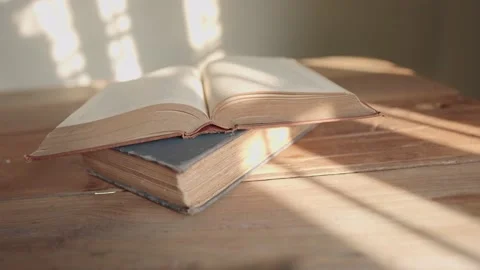 An open book on a wooden table Stock Footage 148101649