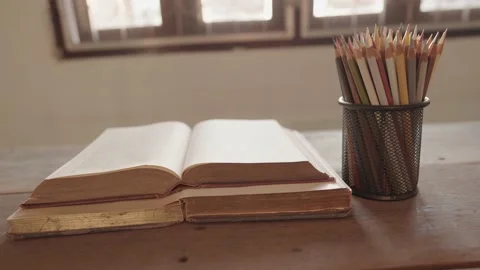 An open book on a wooden table Stock-Footage 148101932