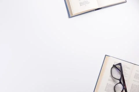 Open books and glasses, isolated on white background. Flat lay, top view, cop Stock Photos