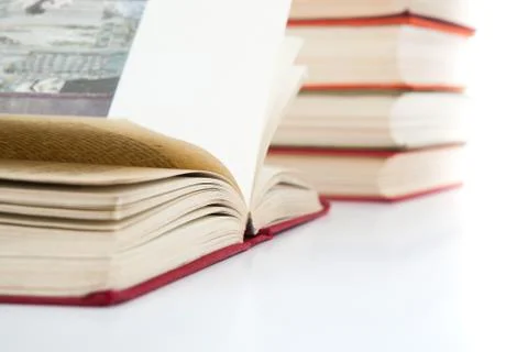 Open books and stack of books on white Stock Photos
