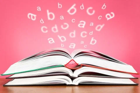 Open books with glowing letters flying out Stock Illustration