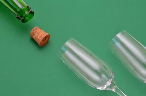 An open bottle and two empty glasses Stock Photos