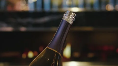 An open bottle of champagne on the background of an evening restaurant Stock Footage 221706365