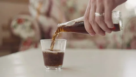 Open a bottle of cold cola and pour into a glass Video stock 139044279