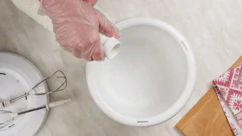 Open a bottle of milk, kefir and pour it into a bowl of a kitchen mixer. Stock Footage 148928610