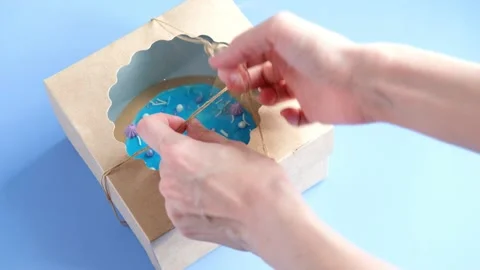Open box with blue bento cake in on blue background, top view Stock Footage 233831351