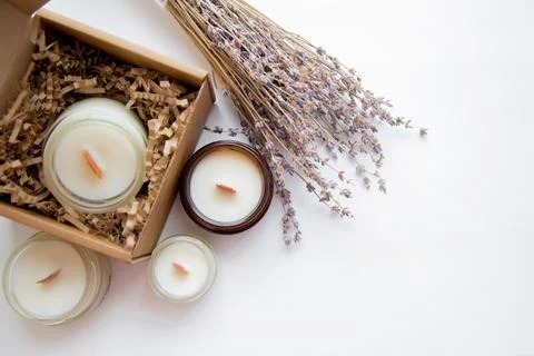 An open box with candles on a white background, next to it are several candles Stock Photos