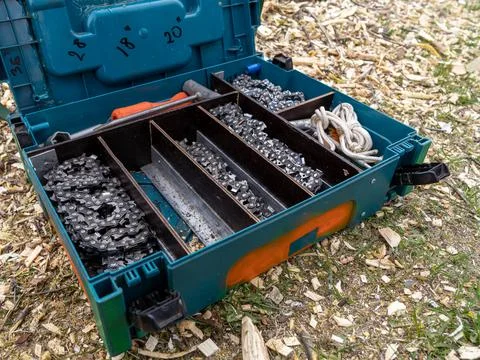 Open box with chainsaw chains in different sizes. Stock Photos