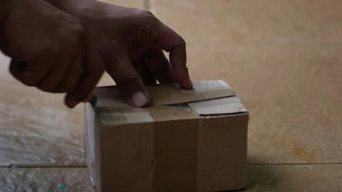 Open a box or small package with a cutter Stock Footage 327788703